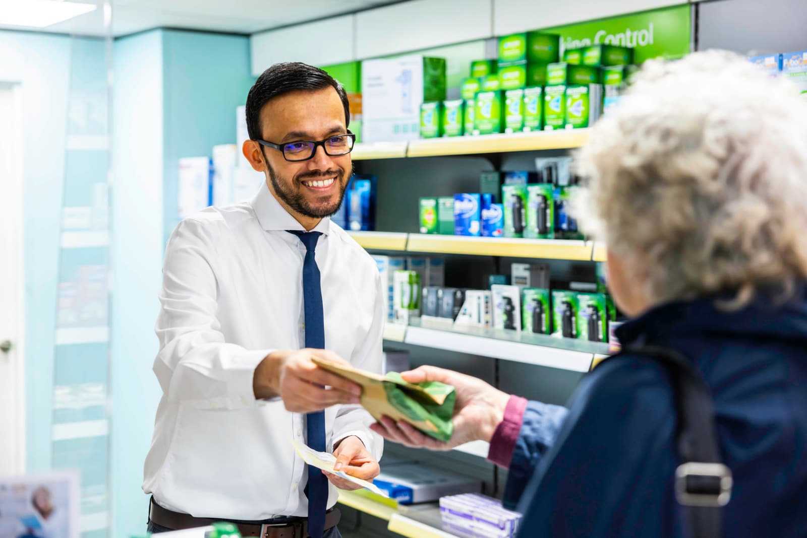 Ringmer Pharmacy pharmacist helping a customer at the service counter